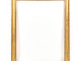 an empty wooden frame on a white wall