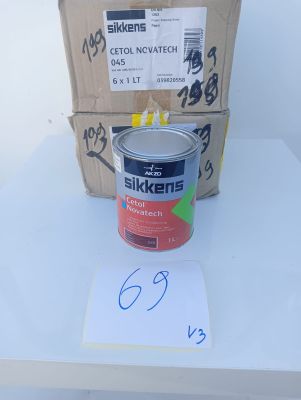 a can of paint sitting on a table next to a box of boxes
