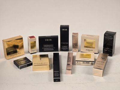several different types of lipsticks and boxes on a white surface