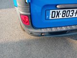 a blue car that is parked on the side of the road