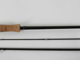 a close up of two fishing rods on a white surface