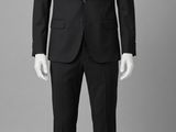 the mannequin is dressed in a black suit and white shirt