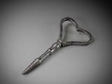 an old key shaped like a heart on a gray background