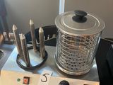 a blender with knives on a table next to a chair
