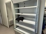 an empty refrigerator in the middle of a room