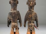 pair of wooden figurines of a man and a woman
