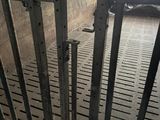 an image of a jail cell with a metal gate