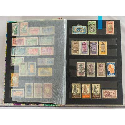 an open book with stamps on it sitting on top of a table