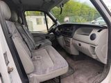 the interior of a white truck with two seats and a steering wheel