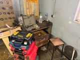 a pile of tools sitting on top of a table in a room
