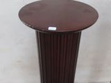 a small table with a brown top and a brown base