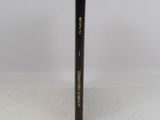 a close up of a black pencil on a white surface