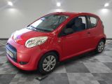 a picture of a small red car parked in a garage