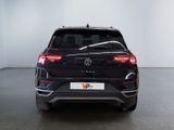 the rear end of a black volkswagen suv parked in a room