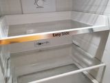 an empty refrigerator with the door open in a kitchen