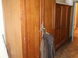 a coat rack in the corner of a room next to a door