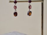 a close up of a pair of earrings sitting on top of a table