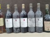 several bottles of wine are lined up on a table