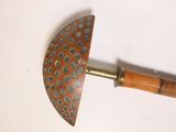 a wooden handle with a blue and brown design on it