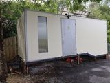 une maison préfabriquée blanche posée au milieu de la route