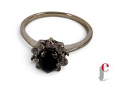 an image of a close up of a ring with a black stone