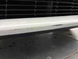 a close up of the front bumper of a white car
