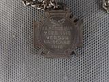a silver necklace that has a medal on it