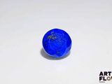 a close up of a blue stone on a white surface