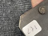 a person holding a knife in their hand with a tag on it