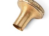 an image of a brass object on a white surface with a white background
