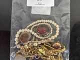 a bag of jewelry that is sitting on a table