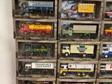 a lot of toy trucks in a display case
