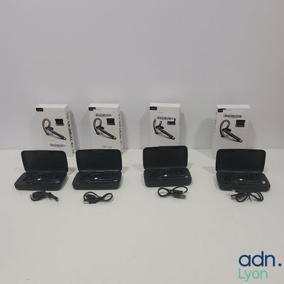 four black laptops are lined up in a row on a white surface