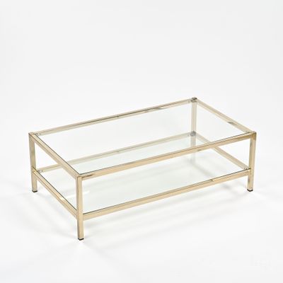 une table basse en verre et laiton avec un plateau en verre transparent