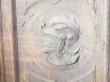 a wooden panel with a carving of a man on it