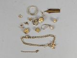 a lot of gold jewelry on a white surface