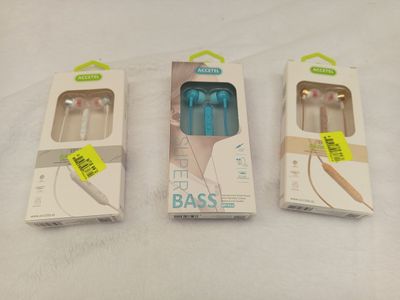 three boxes of ear buds are sitting next to each other