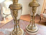 two vases sitting on a marble table in a room
