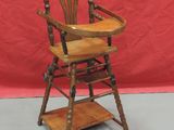wooden high chair with wooden seat and wooden shelf on grey floor