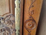 a close up of a wooden door with carvings on it