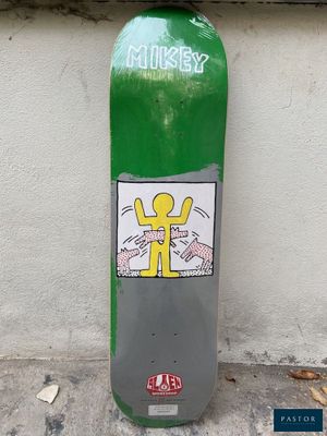 a green fire hydrant with a sticker on the side of it