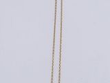 a close up of a necklace on a white surface with a white background