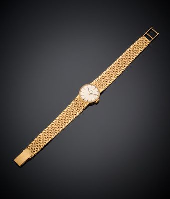 une montre-bracelet en or 18 carats avec un cadran blanc