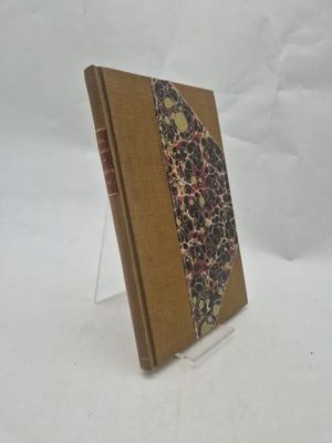 an old book sitting on top of a white table next to a white background