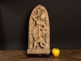 an image of a statue of a woman holding a child next to an apple