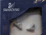 a pair of earrings that are in a box