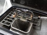 a black stove with a silver grill top and a silver pan