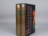 two books sitting on top of each other on a white surface