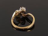 a close up of a gold ring with a flower on it