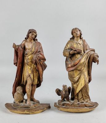 paire de figurines en bois sculpté représentant un homme et une femme accompagnés d'un chien